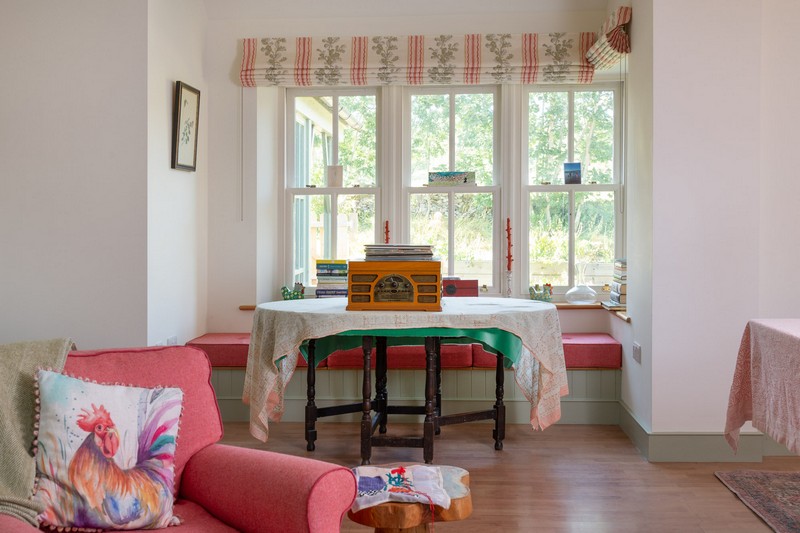 View of bay window in drawing room, Linwood blinds, armchair, record player and tapestry