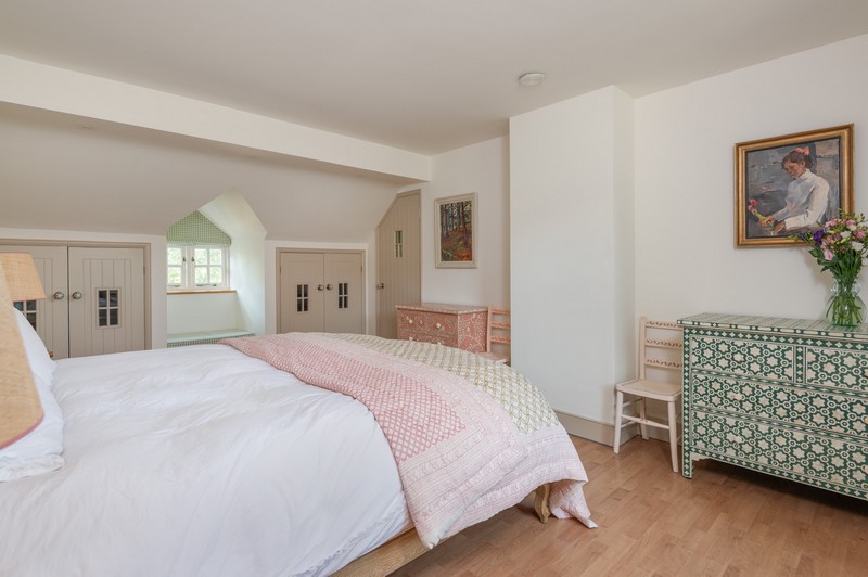 Main bedroom with Ukrainian art work, mother of pearl chest of drawers, hand-painted chairs and bay window