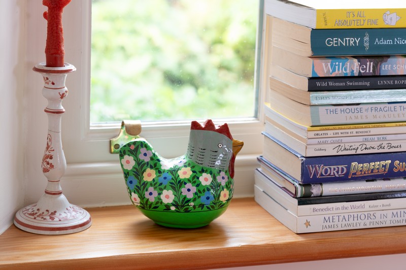 Decorative features, books and candles on bay window ledge in drawing room